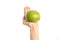 Healthy eating and diet Topic: Human hand holding a green sweetie isolated on a white background in the studio, first-person view