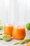 Healthy eating, dieting, food and vegetarian concept - glass with carrot juice, celery and green apple