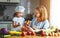 Healthy eating. family mother and child girl preparing vegetarian vegetable salad at home in kitchen