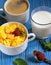 Healthy eating, food and diet concept - Cornflakes with berries, milk and coffee for breakfast. Blue wooden background.