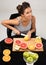 Healthy eating and freshness. The pretty young woman cut citrus fruit