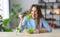 Healthy eating. happy young girl eating salad in the morning in kitchen