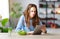 Healthy eating. happy young girl eating salad with tablet pc in morning in kitchen