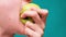 Healthy eating and healthy teeth or diet, young woman bites a fresh apple on a green screen close-up