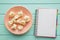 Healthy eating and life planning concept. Notebook for notes, copy space, space for text, turquoise background