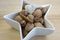 Healthy eating, various nuts in a white bowl, star shaped, wooden table, Christmas decoration