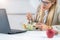 Healthy eating at work. Woman indulges in a delightful fresh salad at her workplace. With every bite, she embraces the nourishing