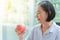 Healthy Elderly hold an apple in hands with happy smile