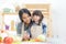 Healthy Family. Mother and kid girl cooking and cutting vegetables for diet on kitchen.