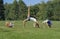 Healthy family practicing yoga in green park.