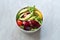 Healthy Fast Food Take Away Salad with Avocado, Beet Slice, Lettuce, Cherry Tomatoes and Sauce in Plastic Box / Package or