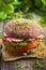 Healthy fast food. Vegan rye burger with fresh vegetables