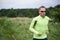 Healthy fit man wearing sunglasses jogging through rural grassland