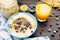 Healthy fitness breakfast with fresh orange juice: oatmeal with bananas, blueberries and cranberries, chia seeds and yogurt on