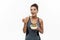 Healthy and Fitness concept - Beautiful American African lady in fitness clothes on diet eating fresh salad. Isolated on