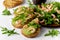 Healthy fitness food. Toasts with avocado, shrimps and arugula salad on white background.