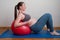 Healthy fitness pregnant woman doing yoga workout on yoga mat. healthy and active pregnancy concept.