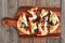 Healthy flatbread pizza on wooden paddle board