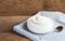 Healthy flavored yogurt in ceramic bowl and spoon on cloth with
