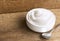 Healthy flavored yogurt in ceramic bowl with spoon on the wood b