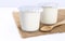 Healthy flavored yogurt in plastic cup with wooden spoon on the