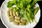 Healthy food, alternative food, parsley in leaves and tablets on a white plate