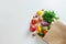 Healthy food background. Healthy vegan vegetarian food in paper bag vegetables and fruits on white, copy space, banner. Shopping