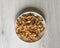 Healthy food for background image close up walnuts. Nuts texture on white grey table top view on the cup plate