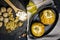 healthy food. Baked apples with cottage cheese and nuts lie in a black baking dish on a black wooden table