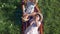 Healthy food, brother and sister in straw hats biting apples lying on plaid on green grass