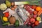 Healthy food clean eating selection: fruit, vegetable, seeds, fish, meat, leaf vegetable on wooden background. Top view