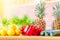 Healthy food collection. Juicy fresh fruits and vegetables. Lemons, paprika bell pepper, pineapples and marrow on wooden table. Se