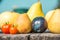 Healthy food composition, apples, pears, plums and tomatoes on rustic wooden table