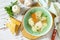 Healthy food concept. Diet turkey soup with vegetables served croutons on a white wooden table.