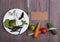 Healthy food and diet vegetarian concept - blank blackboard, measure tape, white plate with leaf of salad, cucumber, tomato and