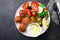 Healthy food dish. Juicy meatballs, fresh vegetables, tomatoes, cucumbers, olives, herbs, herbs with yogurt sauce with
