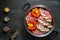 healthy food dish with raw chicken before steaming with mushrooms and vegetables on a black background