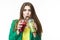 Healthy Food Eating. Smiling Woman Drinking Both Green and Red Detox Vegetable Smoothie. Posing in Green Jacket Over White