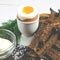 Healthy food. English breakfast with boiled egg and croutons on a white wood background
