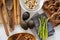 Healthy food flat lay. Asparagus on blue napkin, avocados, pretzel, peanuts in bowl, pecan, cinnamon sticks and anise on