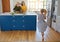 Healthy food is food for the soul. a little girl dancing while her mother and grandmother cooks in the background.