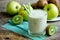 Healthy food green smoothie yogurt kiwi apple ginger and honey in glass