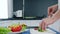 Healthy food, hands slicing fresh green broccoli for salad on cutting board at kitchen