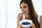 Healthy Food. Happy Woman On Diet Eating Organic Blueberries