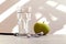 Healthy food - health zoologist: a glass of water, a green apple, a device for measuring blood pressure on a light table against a