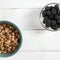 Healthy food: a healthy breakfast of cornflakes and blackberry berries on a white tree table