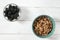 Healthy food: a healthy breakfast of cornflakes and blackberry berries on a white tree table