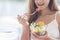 Healthy food healthy lifestyle with young happy woman eating green fresh ingredients organic salad. Vegan girl holding salad bowl