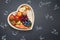 Healthy food in heart and chemical elements on blackboard