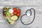 Healthy food in heart and cholesterol diet concept on wooden backgraund with stethoscope